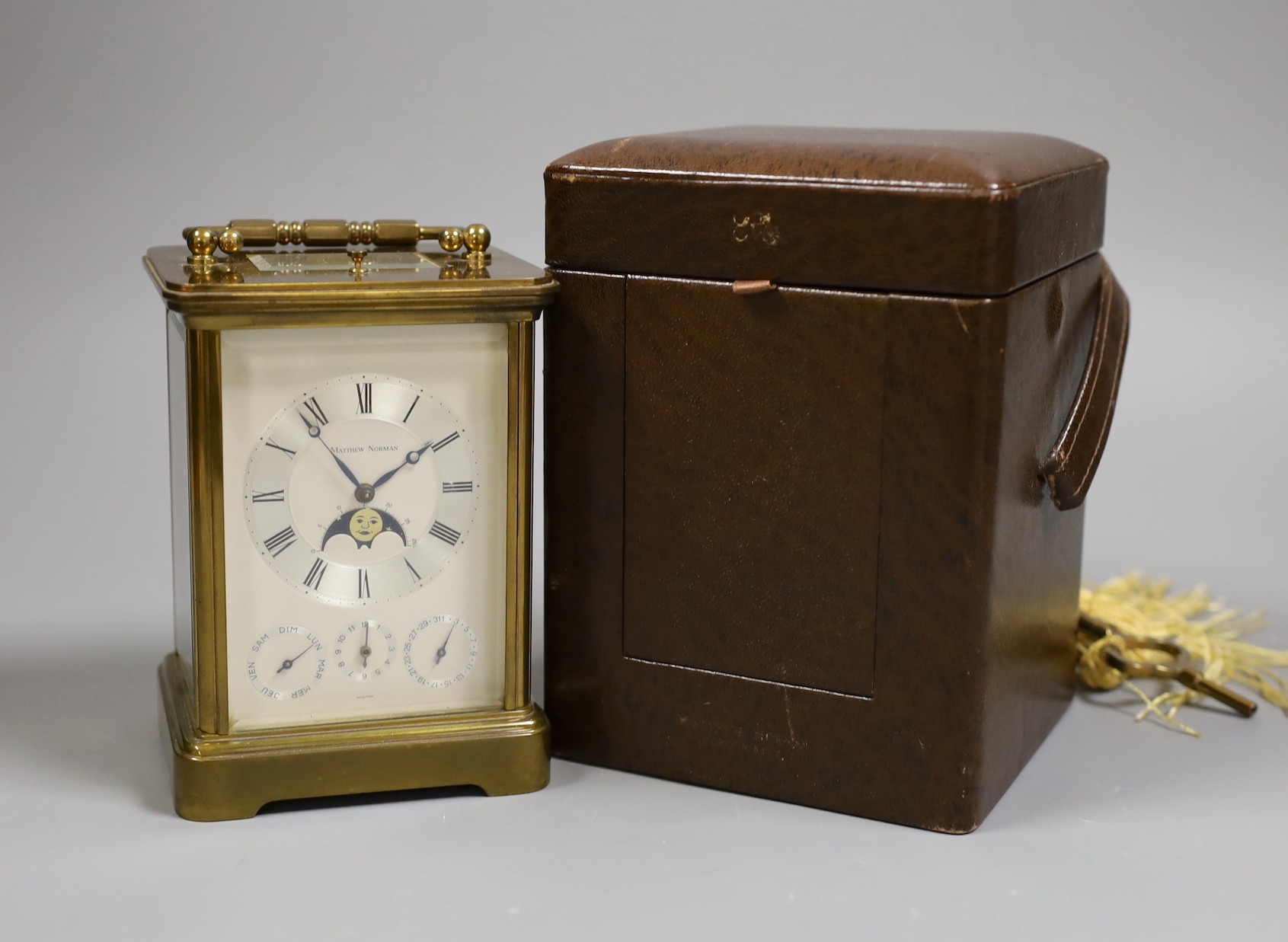 Matthew Norman brass carriage calendar clock and case, 13 cms high not including box